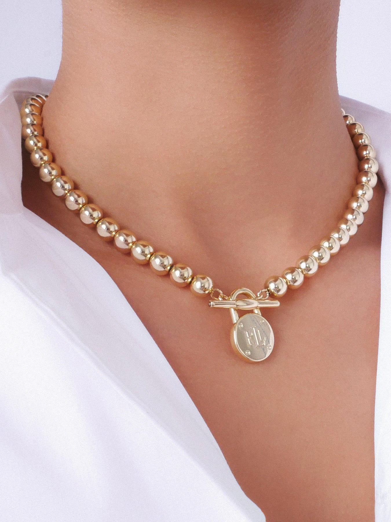 Gold Tone Beaded Toggle Necklace with Lauren Ralph Lauren Padlock