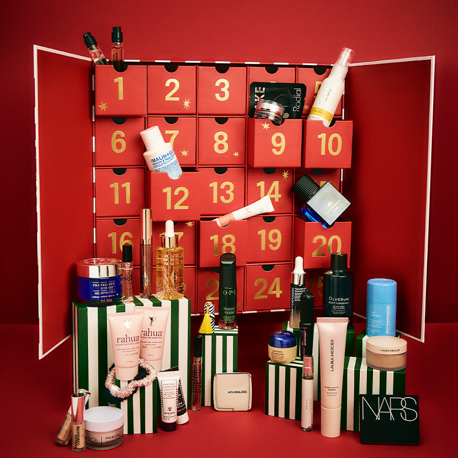 Makeup advent calendar with various cosmetic products on a red background
