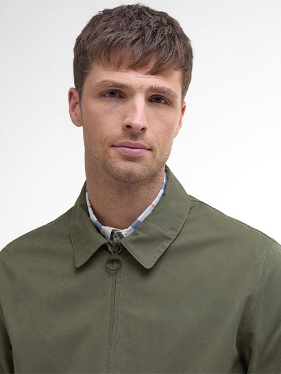 Man wearing a green jacket against a white background